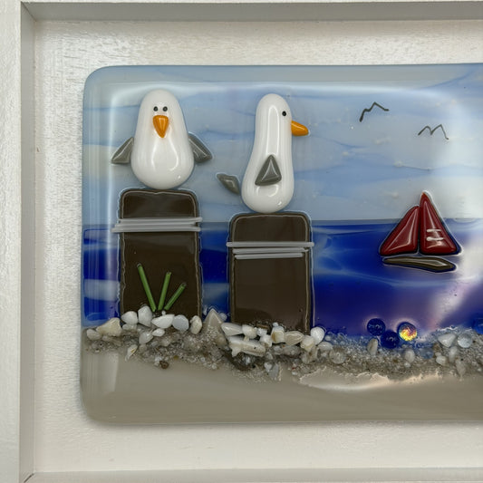 Playful Seagulls on Beach Pilings – Framed Fused Glass Coastal Art Panel